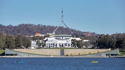 Old and new Parliament house with lake in foreground
