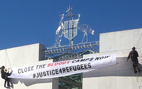 Protesters abseil down the front of Parliament House on 1 December 2016, Image source: A Hough