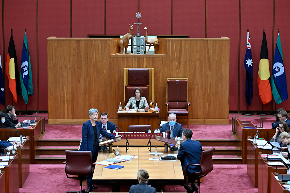 Aboriginal and Torres Strait Islander flags displayed alongside the Australian flag in the Senate Chamber, Image source: AUSPIC
