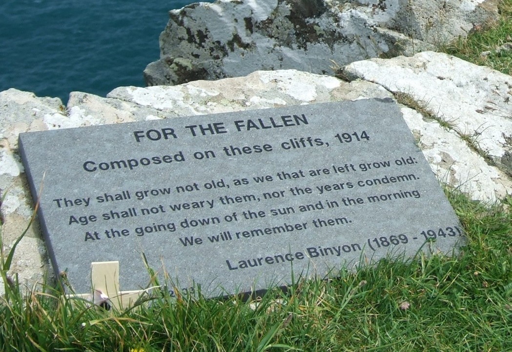 Memorial plaque set atop a cliff face, showing the fourth stanza of Laurence Binyon's poem For the Fallen:
They shall grow not old, as we that are left grow old.
Age shall not weary them nor the years condemn.
At the going down of the sun and in the morning
We will remember them.