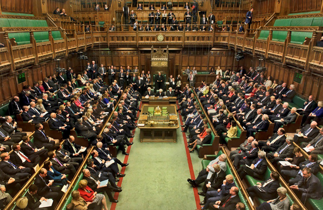 A photo of the British House of Commons with politicians in attendance.