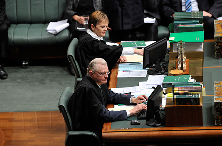 The Clerk and Deputy Clerk on duty at the Table in the House of Representatives Chamber. PHoto: David Foote, AUSPIC/DPS