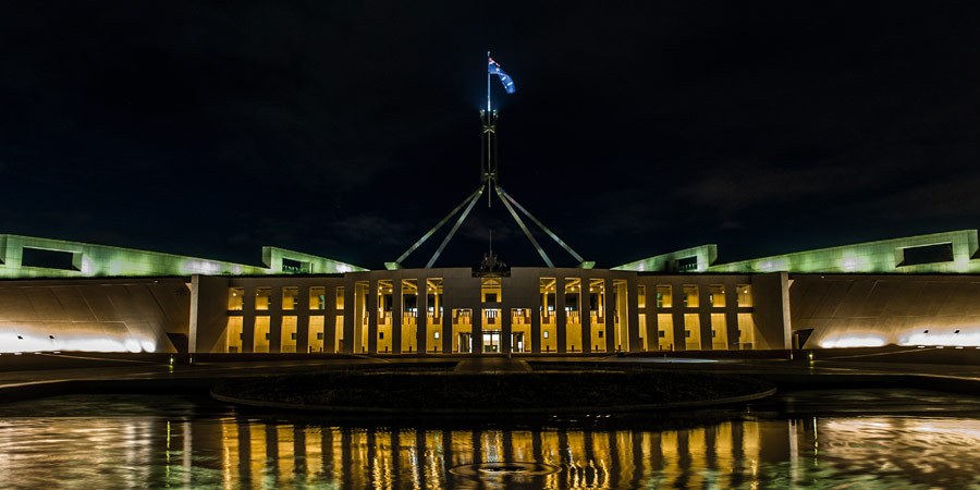 Front of Australian Parliament House lit up at night