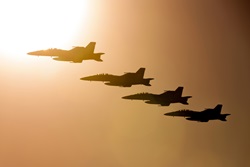 Avalon, Australia - March 1, 2013: Four Royal Australian Air Force (RAAF) Boeing F/A-18F Super Hornet multirole fighter aircraft flying in formation at sunset