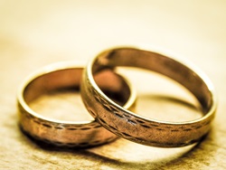 two gold rings resting on a table