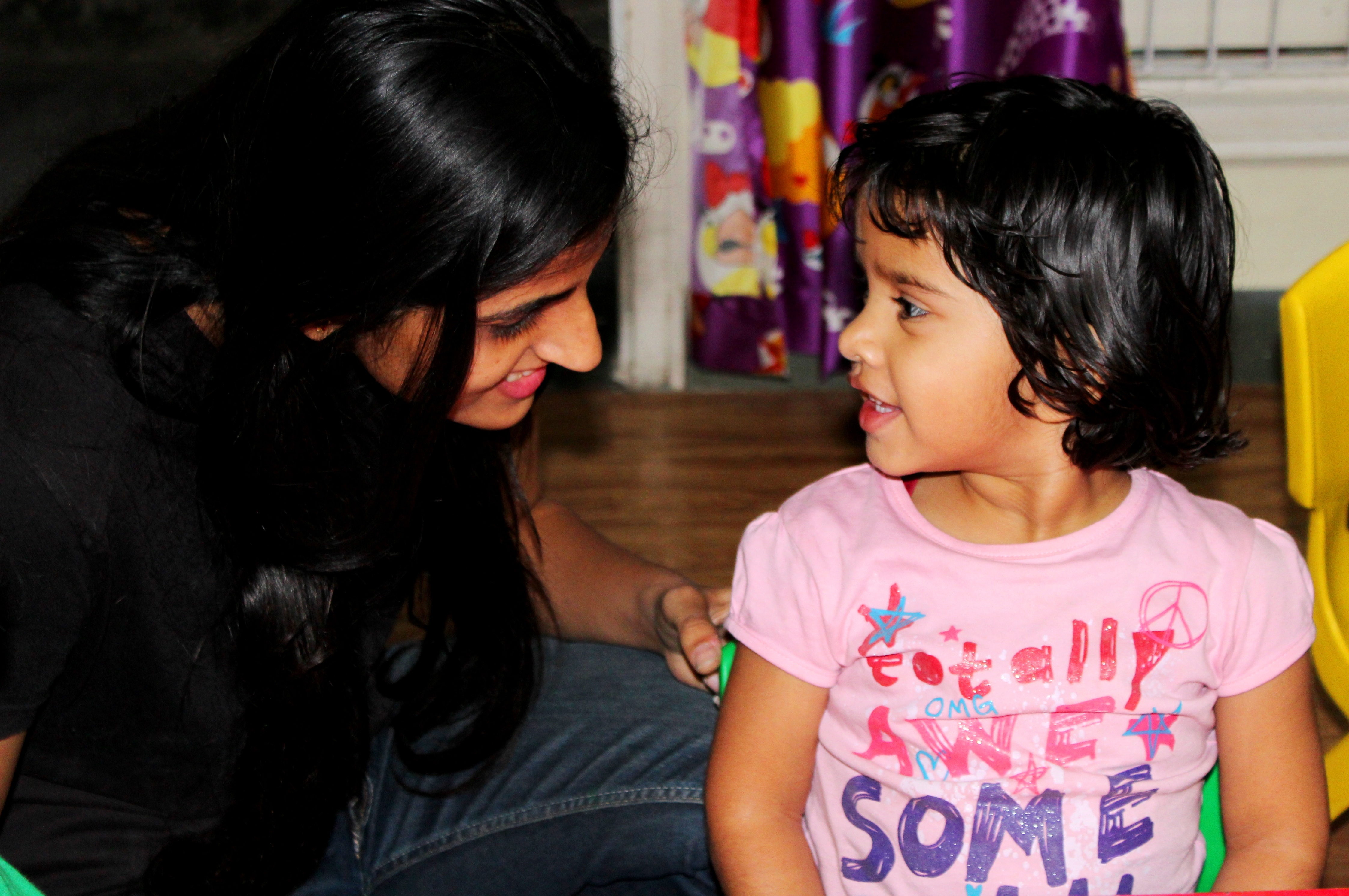 Preschool aged child with childcare educator in a classroom setting