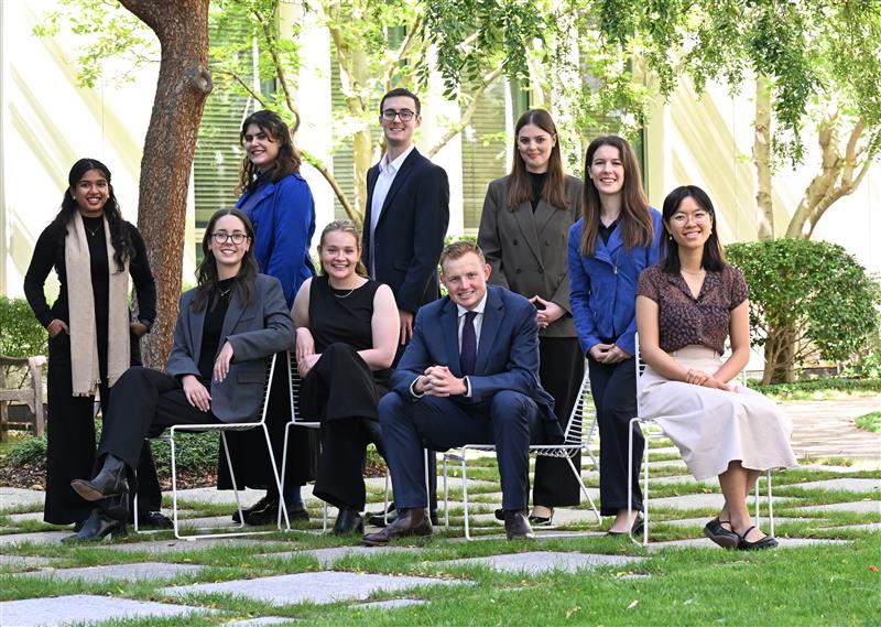 Graduates outside posing for photo