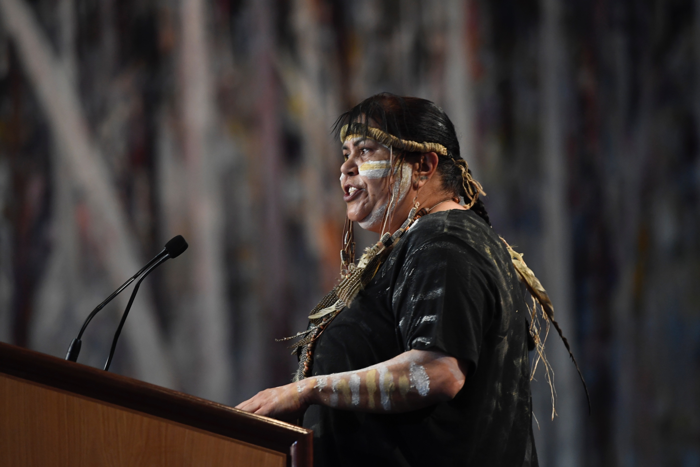 Speaker standing at podium during the Welcome to Country Ceremony