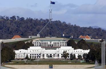 Parliament House, Canberra, showing the Australian Coat of Arms and flag
